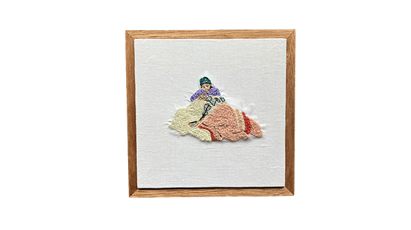 インドの座っている女性刺繍